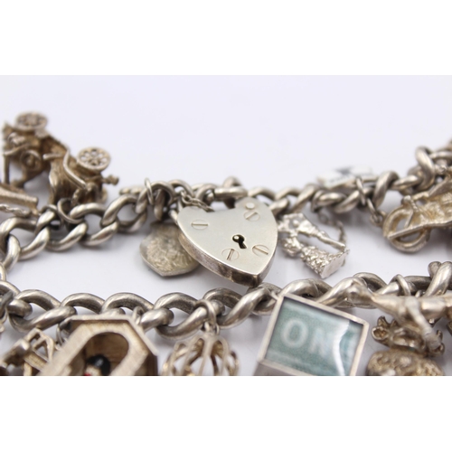 1151 - A .925 silver charm bracelet with assorted charms