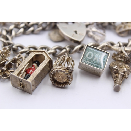 1151 - A .925 silver charm bracelet with assorted charms