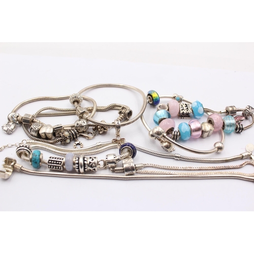 1159 - A collection of .925 silver charm bracelets with assorted charms