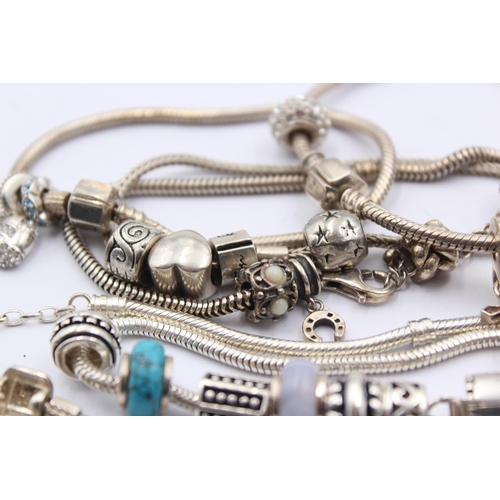 1159 - A collection of .925 silver charm bracelets with assorted charms