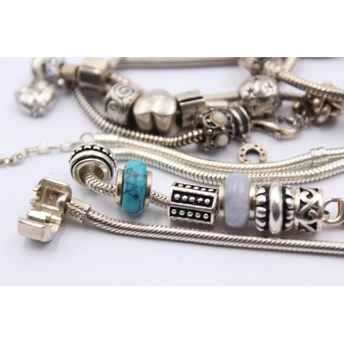 1159 - A collection of .925 silver charm bracelets with assorted charms