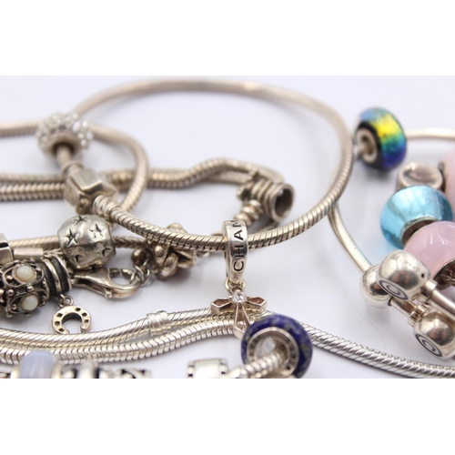 1159 - A collection of .925 silver charm bracelets with assorted charms