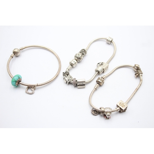 1173 - Three Pandora .925 silver bracelets with assorted charms