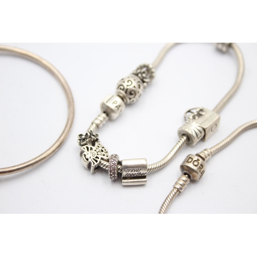 1173 - Three Pandora .925 silver bracelets with assorted charms