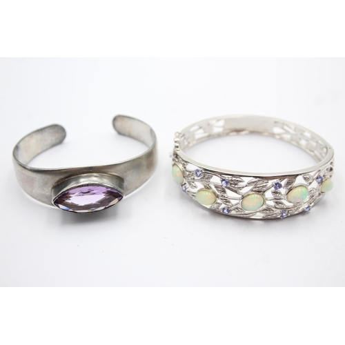 1175 - Two .925 silver gemstone set bangles, one opal and tanzanite and one amethyst - approx. gross weight... 