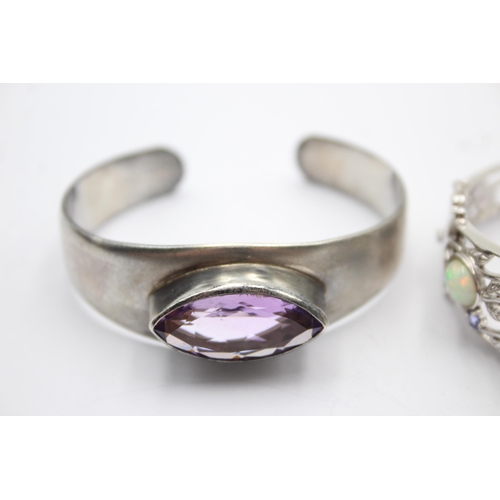 1175 - Two .925 silver gemstone set bangles, one opal and tanzanite and one amethyst - approx. gross weight... 