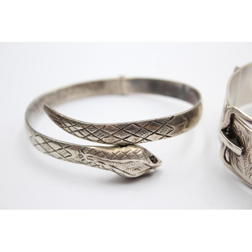 1183 - A .925 silver buckle bangle and snake bangle with garnet set eyes