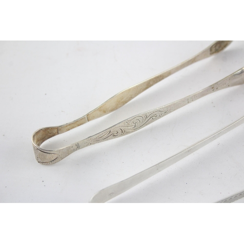 1326 - Two pairs of Georgian hallmarked sterling silver sugar tongs - approx. gross weight 61 grams