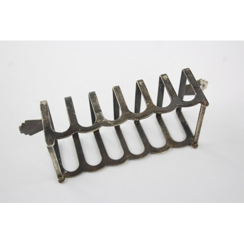 1351 - A Barker Bros Ltd sterling silver seven bar toast rack, hallmarked Birmingham 1960 - approx. gross w... 