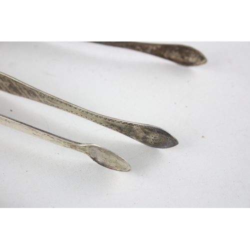 1367 - Two pairs of Georgian hallmarked sterling silver sugar tongs - approx. gross weight 67 grams