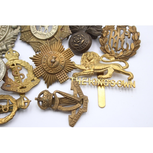 1396 - Ten military cap badges to include R.F.C, Canadian, Irish etc.