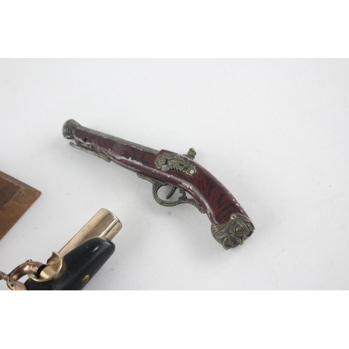 1409 - Three vintage novelty gun shaped cigarette/table lighters