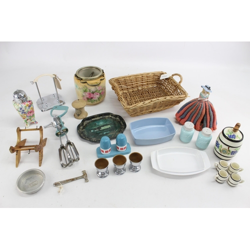 667 - A collection of vintage kitchenalia to include ceramic tableware, wicker etc.