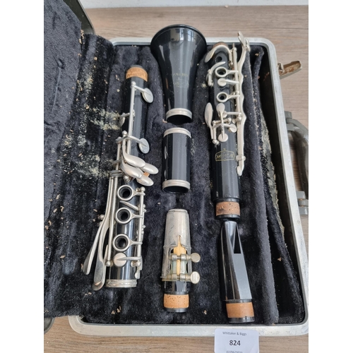 A cased vintage Bundy by Selmer B flat with two mouth pieces