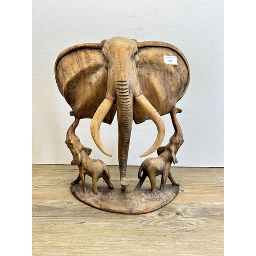 687 - An African carved teak elephant sculpture - approx. 42cm high x 32cm wide