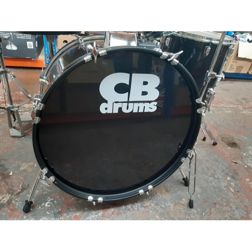 822A - A black CB Drums five piece drum kit comprising bass drum, floor tom, two rack toms, snare on stand,... 