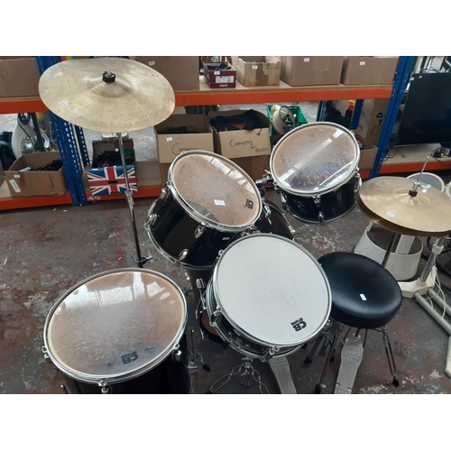 822A - A black CB Drums five piece drum kit comprising bass drum, floor tom, two rack toms, snare on stand,... 