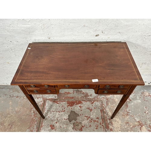 10 - An Edwardian inlaid mahogany writing table with five drawers and tapering supports - approx. 74cm hi... 