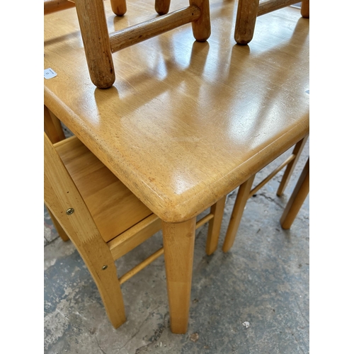 11 - A modern beech square dining table with two matching dining chairs and two pine circular top stools