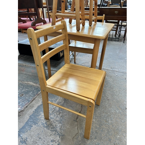 11 - A modern beech square dining table with two matching dining chairs and two pine circular top stools