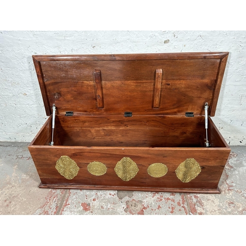 14 - An Indian sheesham wood blanket box with brass detailing