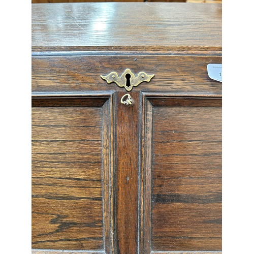 16 - A 1930s oak bureau with two drawers, fall front and baluster supports