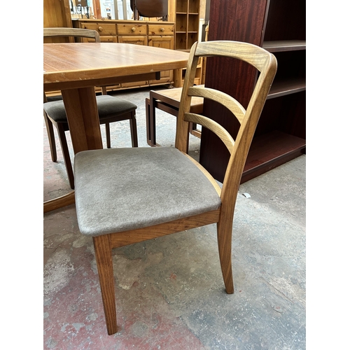 19 - A mid 20th century teak extending dining table and four G Plan teak dining chairs - approx. 250cm wh... 