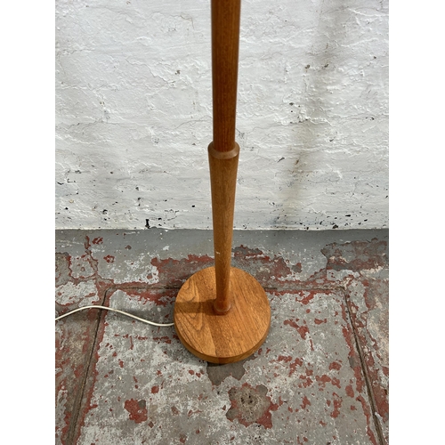 25 - A mid 20th century teak standard lamp - approx. 128cm high