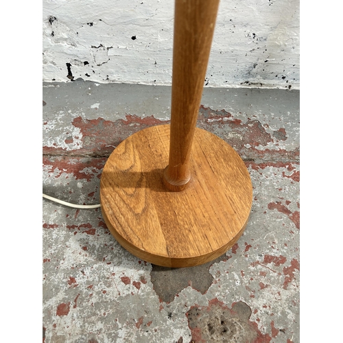 25 - A mid 20th century teak standard lamp - approx. 128cm high