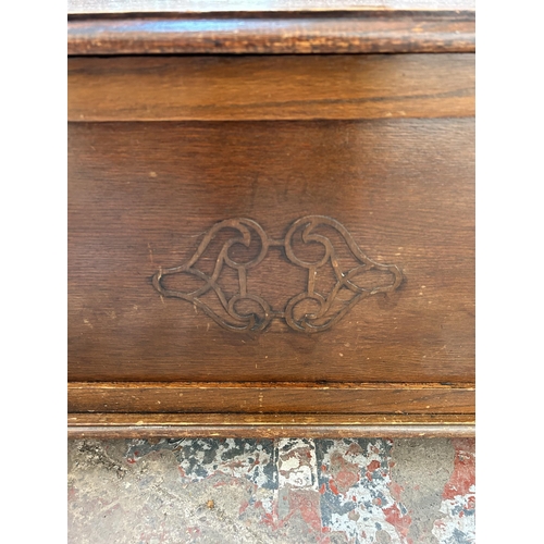 3 - An oak blanket box with carved front and baluster supports