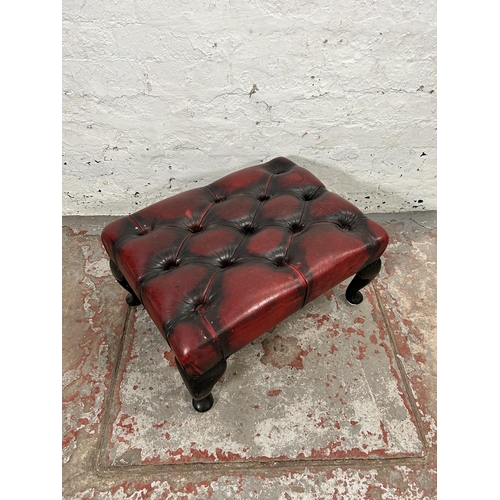 34 - An oxblood leather Chesterfield footstool with cabriole supports