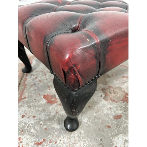 34 - An oxblood leather Chesterfield footstool with cabriole supports