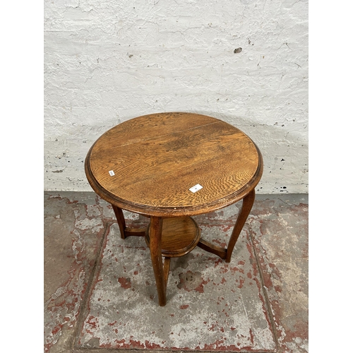 38 - An early/mid 20th century oak circular two tier side table