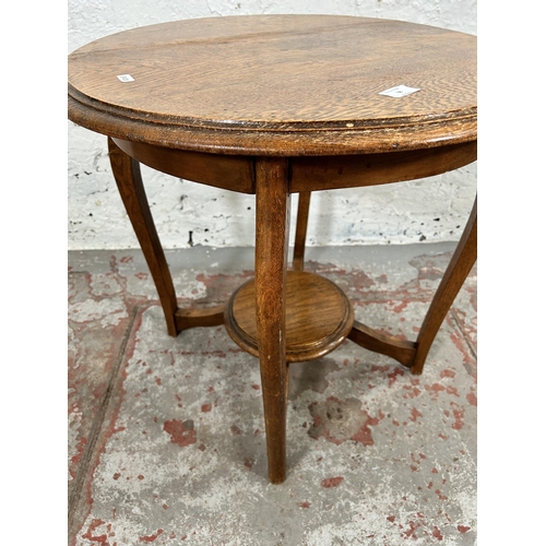 38 - An early/mid 20th century oak circular two tier side table