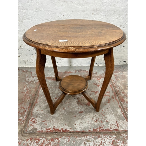 38 - An early/mid 20th century oak circular two tier side table