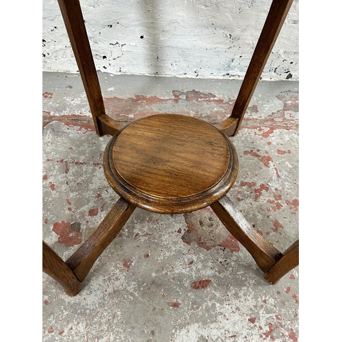 38 - An early/mid 20th century oak circular two tier side table