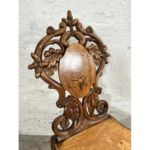 39 - Two 19th century Black Forest carved and inlaid walnut hall chairs, circa 1880 - approx. 92cm high x... 