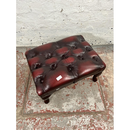 43 - An oxblood leather Chesterfield footstool with cabriole supports