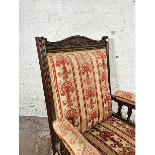 5 - An Edwardian carved oak and fabric upholstered armchair