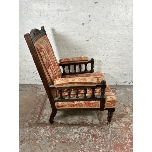 5 - An Edwardian carved oak and fabric upholstered armchair