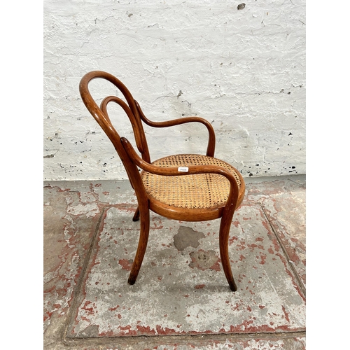 54 - A Thonet style bentwood and cane child's armchair - approx. 64cm high x 37cm wide x 35cm deep