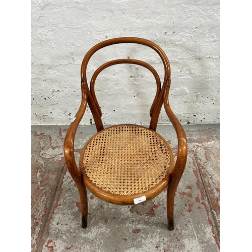 54 - A Thonet style bentwood and cane child's armchair - approx. 64cm high x 37cm wide x 35cm deep