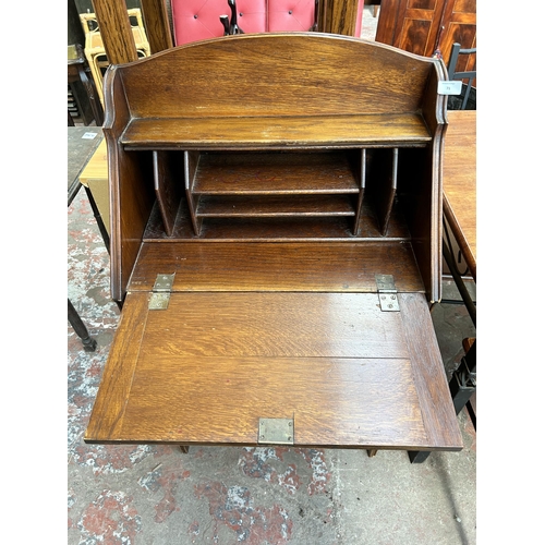 71 - An early/mid 20th century oak bureau with fall front and two cupboard doors