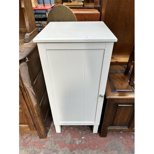 74 - A modern white laminate bathroom cabinet with three internal shelves