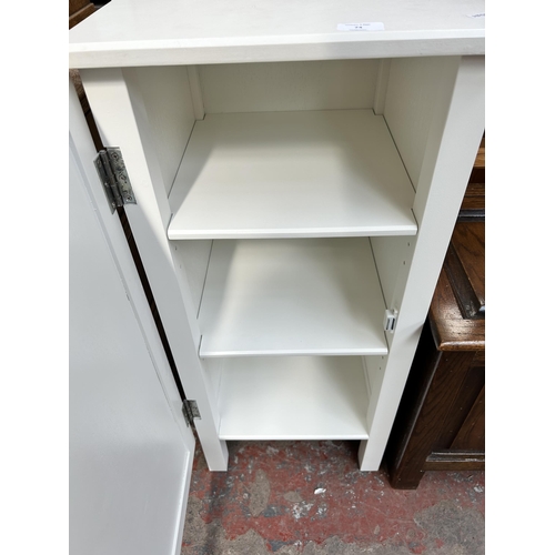 74 - A modern white laminate bathroom cabinet with three internal shelves