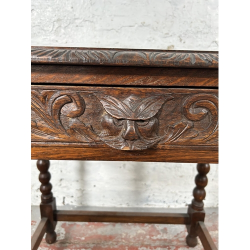 8 - A Victorian carved oak rectangular side table with green man design, barley twist supports and singl... 