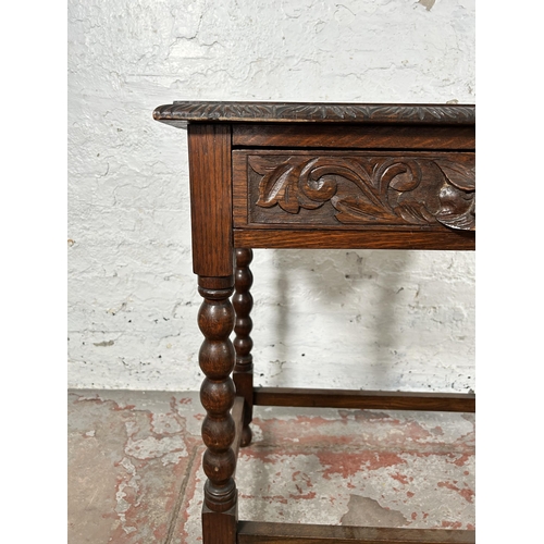 8 - A Victorian carved oak rectangular side table with green man design, barley twist supports and singl... 