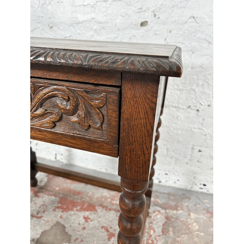 8 - A Victorian carved oak rectangular side table with green man design, barley twist supports and singl... 