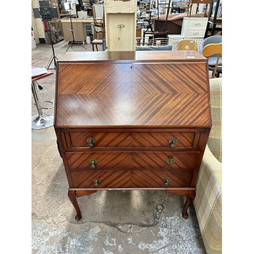 80 - An early 20th century mahogany bureau with three drawers, fall front and cabriole supports