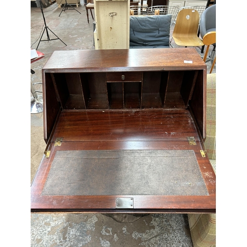 80 - An early 20th century mahogany bureau with three drawers, fall front and cabriole supports